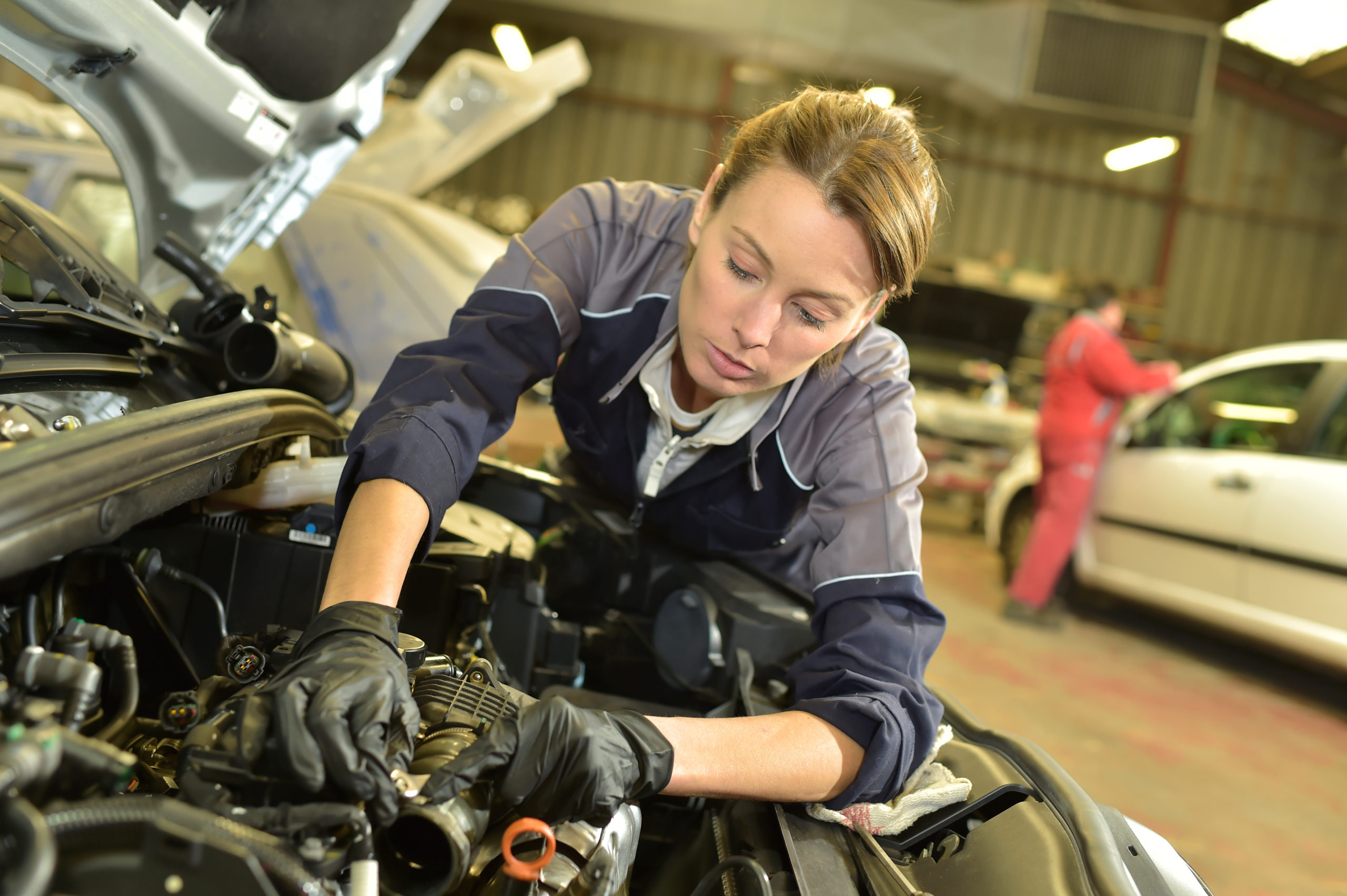 mechanic working on a car in a repair workshop